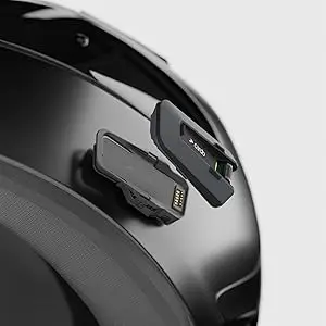 Close-up showing the cardo packtalk pro easily attaching to its helmet base via the magnetic Air Mount system.